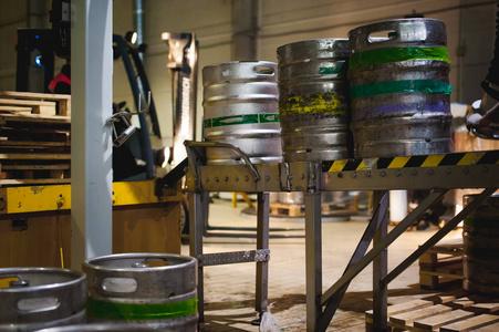 过程转移的铝桶从灌装线的托盘上,员工的啤酒生产线,生产专用设备的
